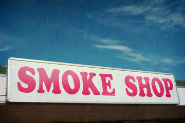 aged and worn smoke shop sign