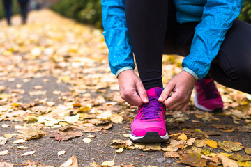 Young sport woman doing exercises during autumn training outside