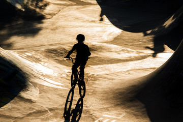 BMX teenage bicycle rider in halfpipe