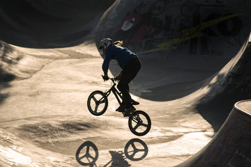 BMX teenage driver in halfpipe