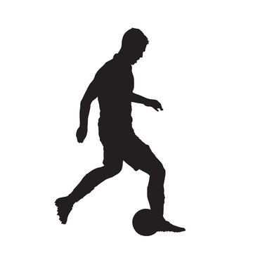 Soccer player kicking ball, isolated vector silhouette. Side view
