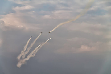 Five airplanes in the sky at an air show