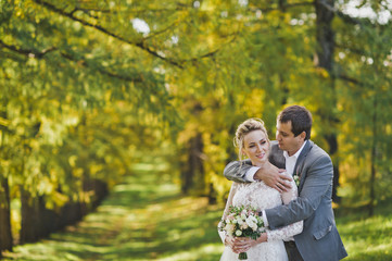 The newlyweds walk along the shady Avenue 40.