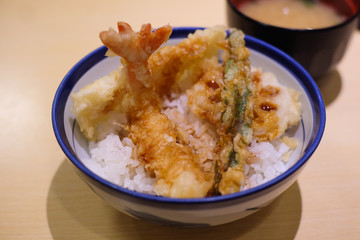 shrimp and vegetable fried with rice on ceramic bowl, japanese food on wood table