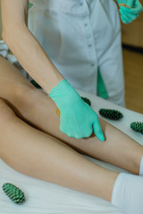 Sugaring. The girl beautician deals customer foot sugar wax.