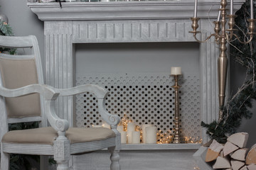 Christmas decoration - room with beautiful chair, fireplace and christmas tree
