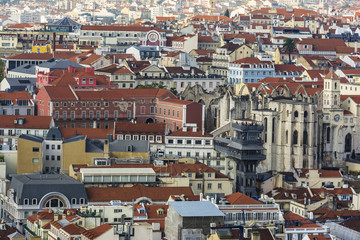 Fototapeta na wymiar Lisbon from above: view of Baixa district with Santa Justa Lift, also called Carmo Lift and Convento da Ordem do Carmo, historical church. View from Castelo de Sao Jorge.