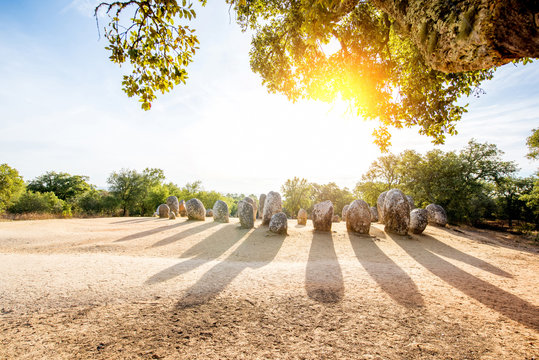 Sunrise view on the menhirs stones in megalithic monument of Cromelech dos Almendres in Portugal