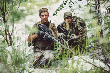 Army sniper during the military operation in the mountain. war, army, technology and people concept..