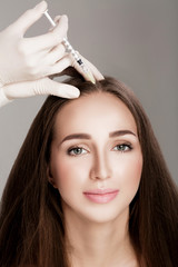 Naklejka premium Cosmetic been injected in woman's head.