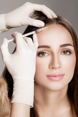 Fototapeta premium Cosmetic been injected in woman's head.