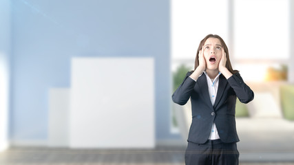 Young beautiful business woman and creative designer standing over blured interior background