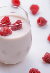 Light raspberry yogurt, yoghurt  on the white wood table 