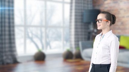 Young beautiful business woman and creative designer standing over blured interior background