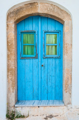 Fototapeta na wymiar Vintage blue door in Kythera island of Greece