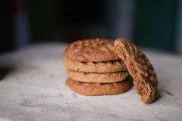 Homemade Peanut Butter Cookies and cookie bited on Light Wooden table with dark background