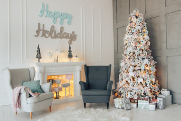Beautiful new-year interior of room. Fir-tree fire-place bed and gifts