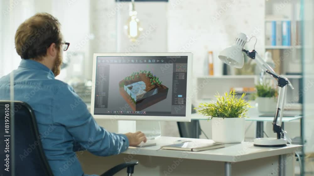 Poster Video Game Designer Works on a New 3D Level on His Personal Computer. He Works as a Developer in a Modern and Bright Creative Studio Environment.