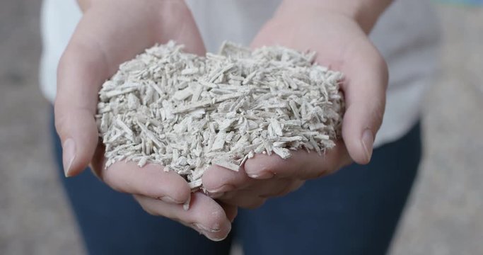 Hempcrete shreds isolating material presented in hands