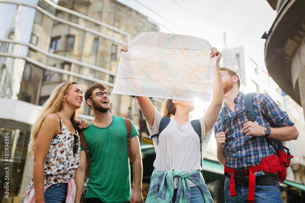 Wall mural Young happy tourists sightseeing in city