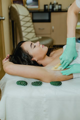 Sugaring. The girl beautician deals on sensitive areas of hands sugar wax.