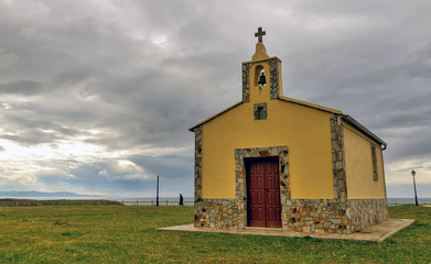 Fototapeta premium Yellow chapel in coastal Asturias, Northern Spain