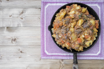 stewed vegetables with beans and meat in a frying pan