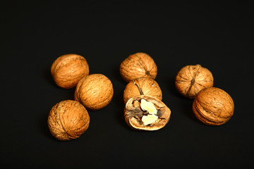 Ripe organic walnuts isolated on a black background  