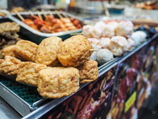 Stinky tofu on a stick and other typical street food sold at a small food stall in central Hong Kong