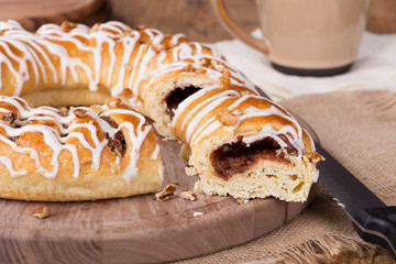 Sliced Cinnamon Pecan Danish on a Wooden Platter