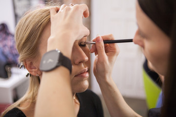 makeup artist applying eyes makeup