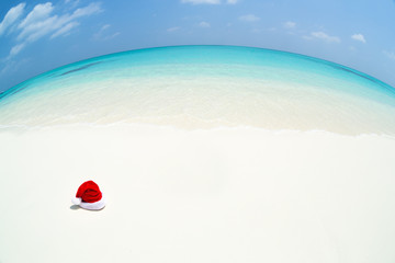 Santa Claus hat on perfect tropical bounty beach