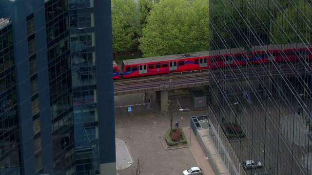 Tram between buildings,Dlr Train, Financial Ticker, Canary Wharf, London
