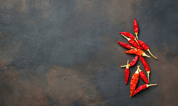 Red hot chili peppers on rusty background