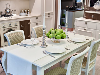 Dining table in kitchen with cutlery