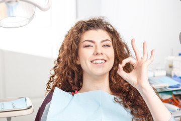 Dentist OK, beauty woman show. In dentist office