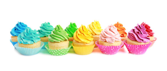 Tasty colorful cupcakes on white background
