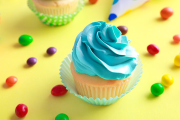 Tasty cupcake on color background