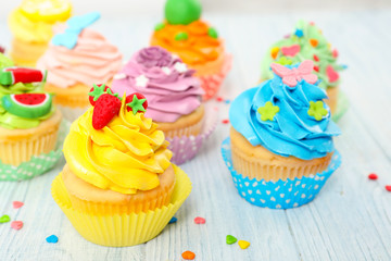 Beautiful cupcakes on wooden table
