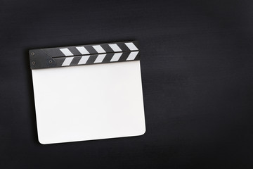 Blank clapper board on chalkboard texture