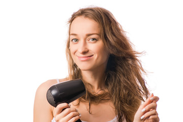 Beautiful young woman dries hair with a hairdryer beauty