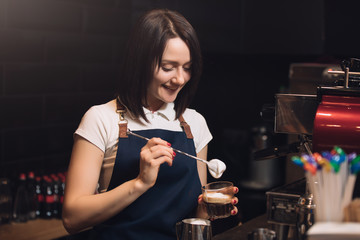 Barista add cream in coffee