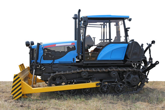 Blue building bulldozer tractor on grass