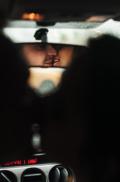 The guy with the girl kiss in the car. a kiss reflected in the rear view mirror
