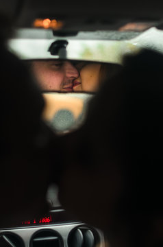 The guy with the girl kiss in the car. a kiss reflected in the rear view mirror