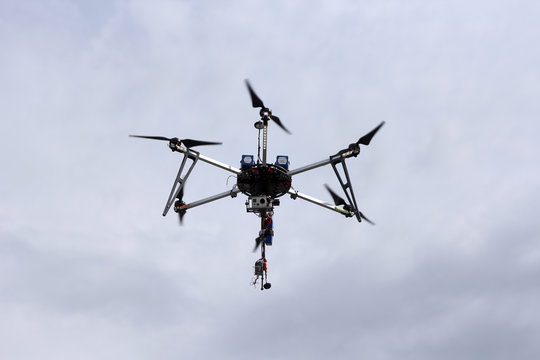 Flying  drone in the sky with mounted  digital camera