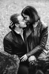 The guy with the girl walking in the Park , in a good mood. dressed in jackets, autumn time.