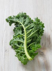 kale on white wooden surface