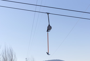 Snowboarder using a surface lift on the slope.