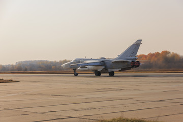 Fototapeta na wymiar Military jet bomber Su-24 Fencer afterburner takeoff